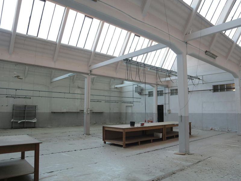 Spacious living room with a yoga mat on the floor near a large window.